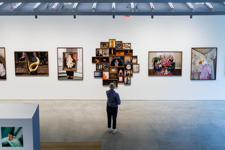 A cluster of photographs making up one art piece in a photography exhibit. 