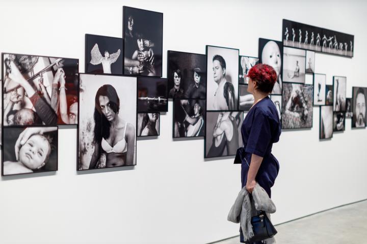 A woman going through an ICP photography exhibit. 
