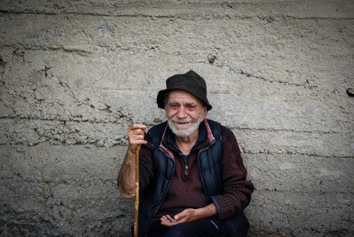 Picture of an old man holding a stick