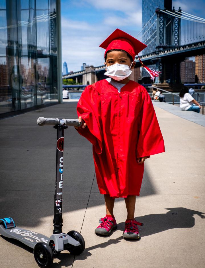 Kid in a graduation gown and cap 