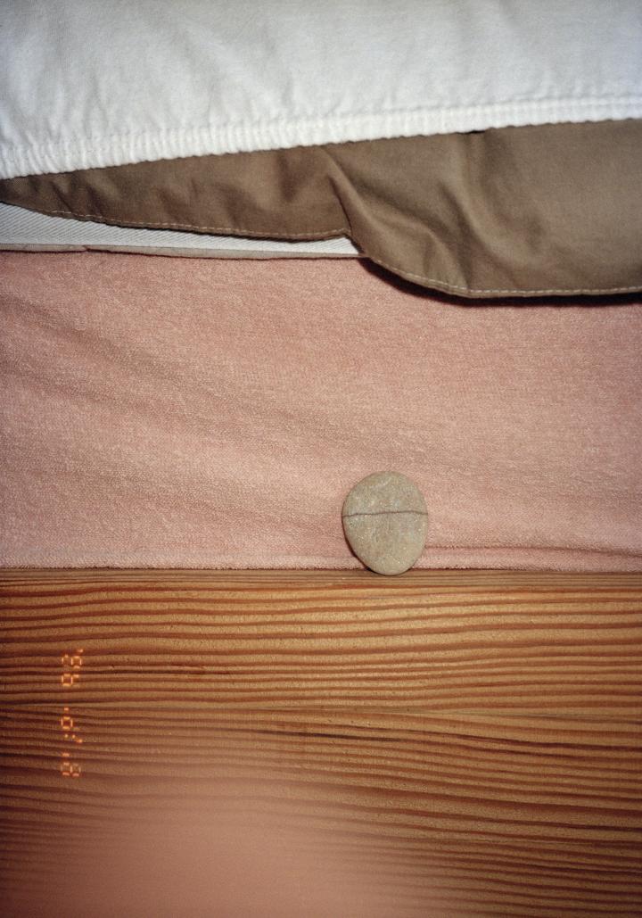 A rock on a bed.