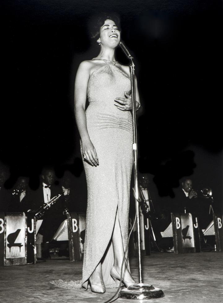 A lady singing on stage.