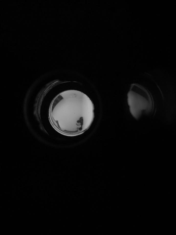 Looking through binoculars.