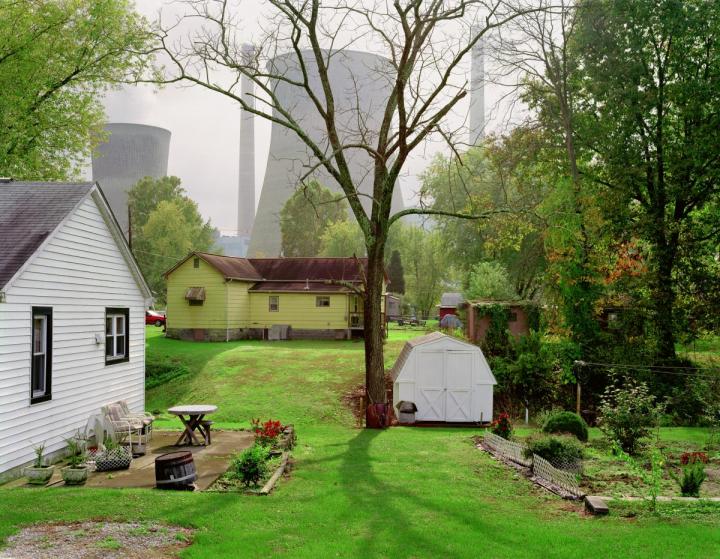 A picture of houses next to a nuclear plant.