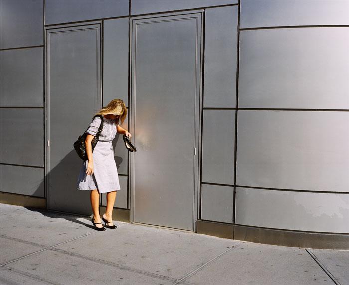 A lady outside a building.