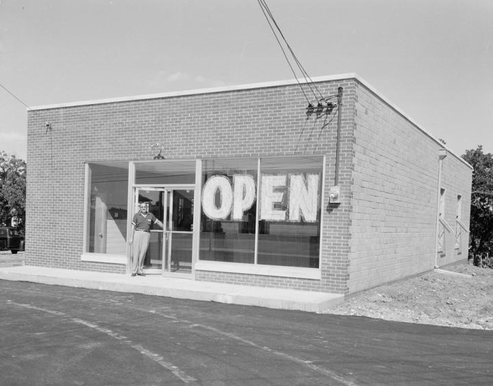 A picture of a store with the words open.