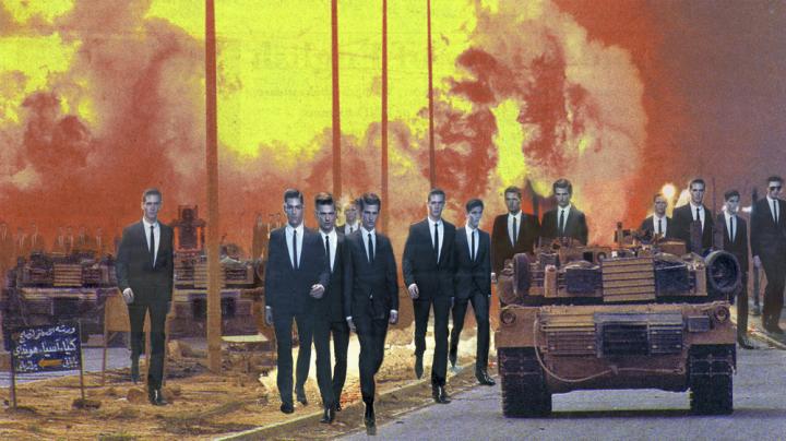 A group of men walking next to a tank.