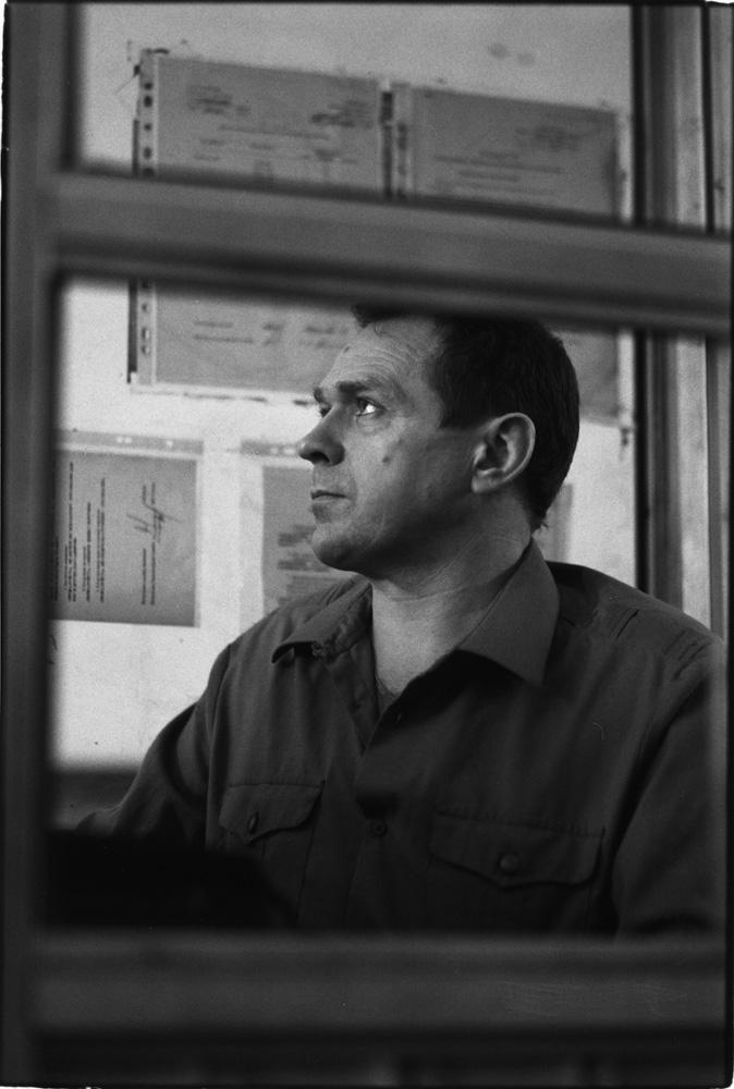 A picture of a man through a window.