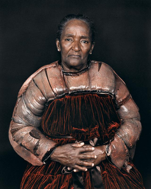 A older woman in her culture's dress. 