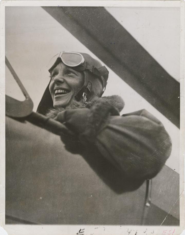 Amelia Earhart in a biplane. 