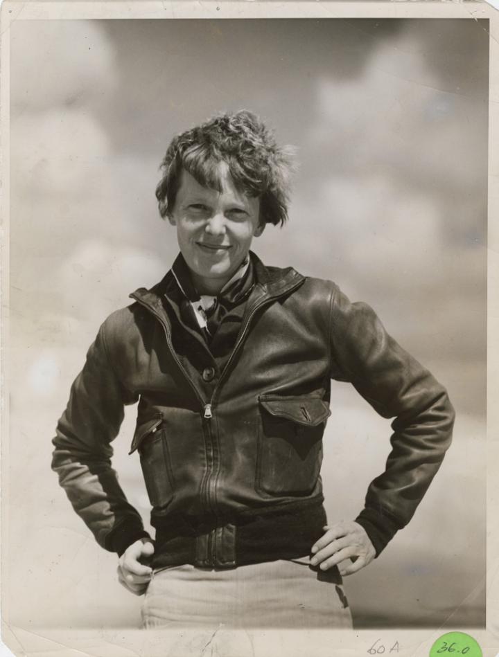 Amelia Earhart with her hands on her hips. 