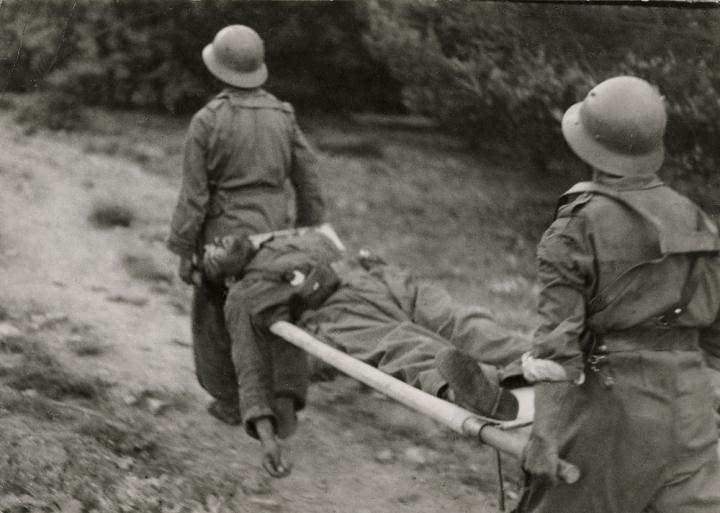 A mortally wounded man on a cot. 