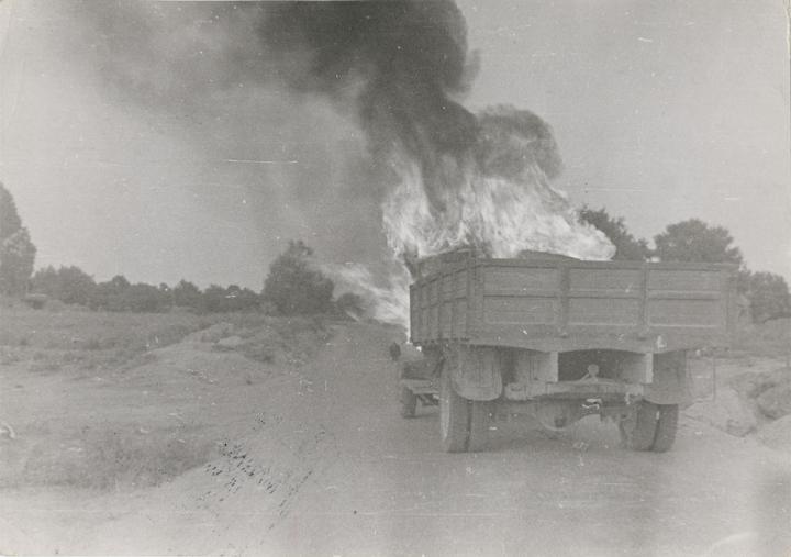 The backside of a truck engulfed in flames. 
