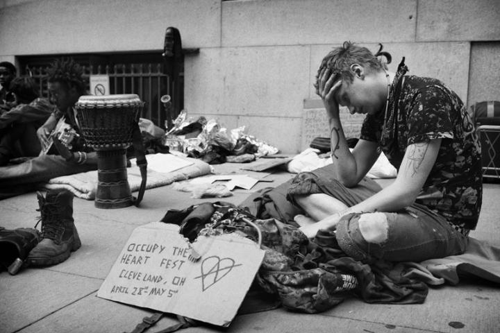 A tired anarchist with his head in his hands during the Occupy Wall-Streeter movement. 