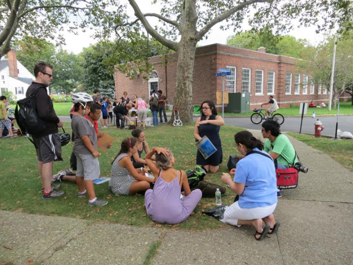 A class being taught outside on the lawn. 