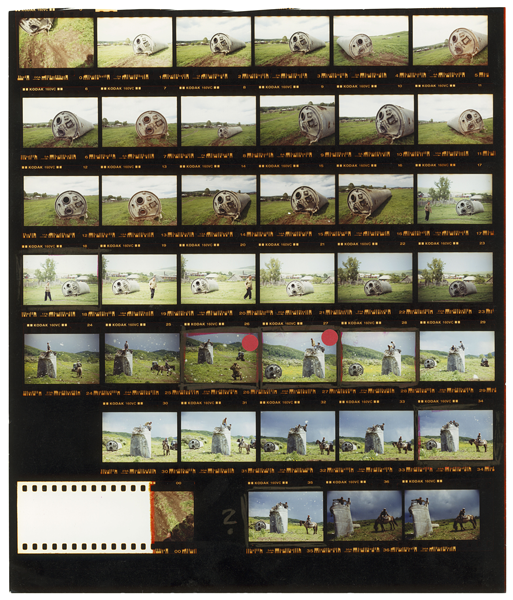 A series of film frames about a spaceship crash landing on a green field. 