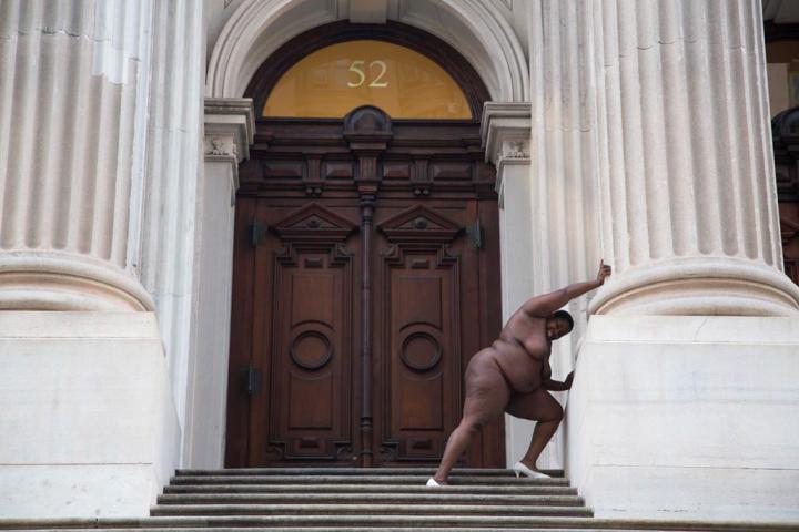 Nude lady outside a building