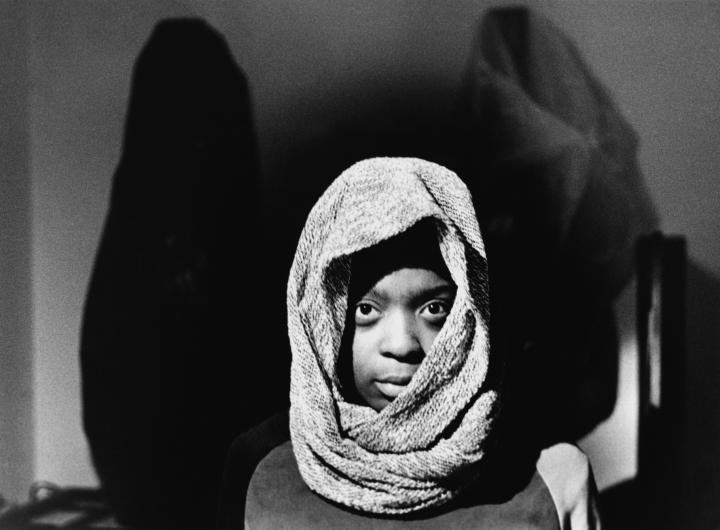 Black and white image of a child with a hood
