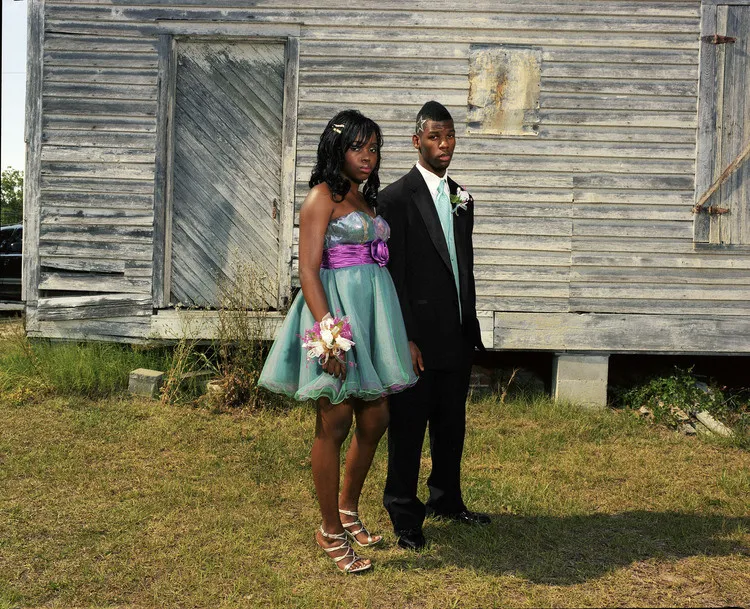 A man and woman standing outside.