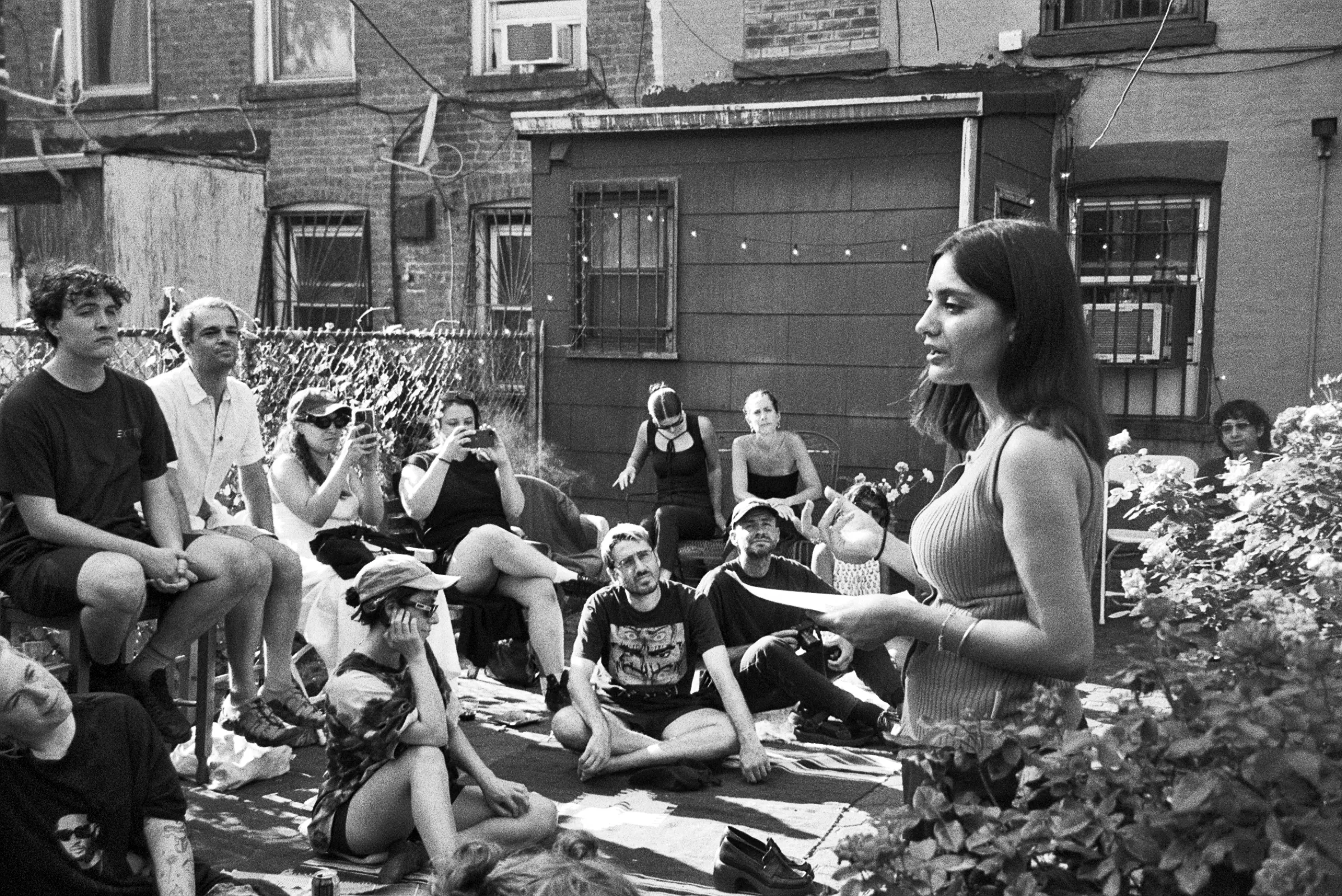 Image a of a person reading in a garden.