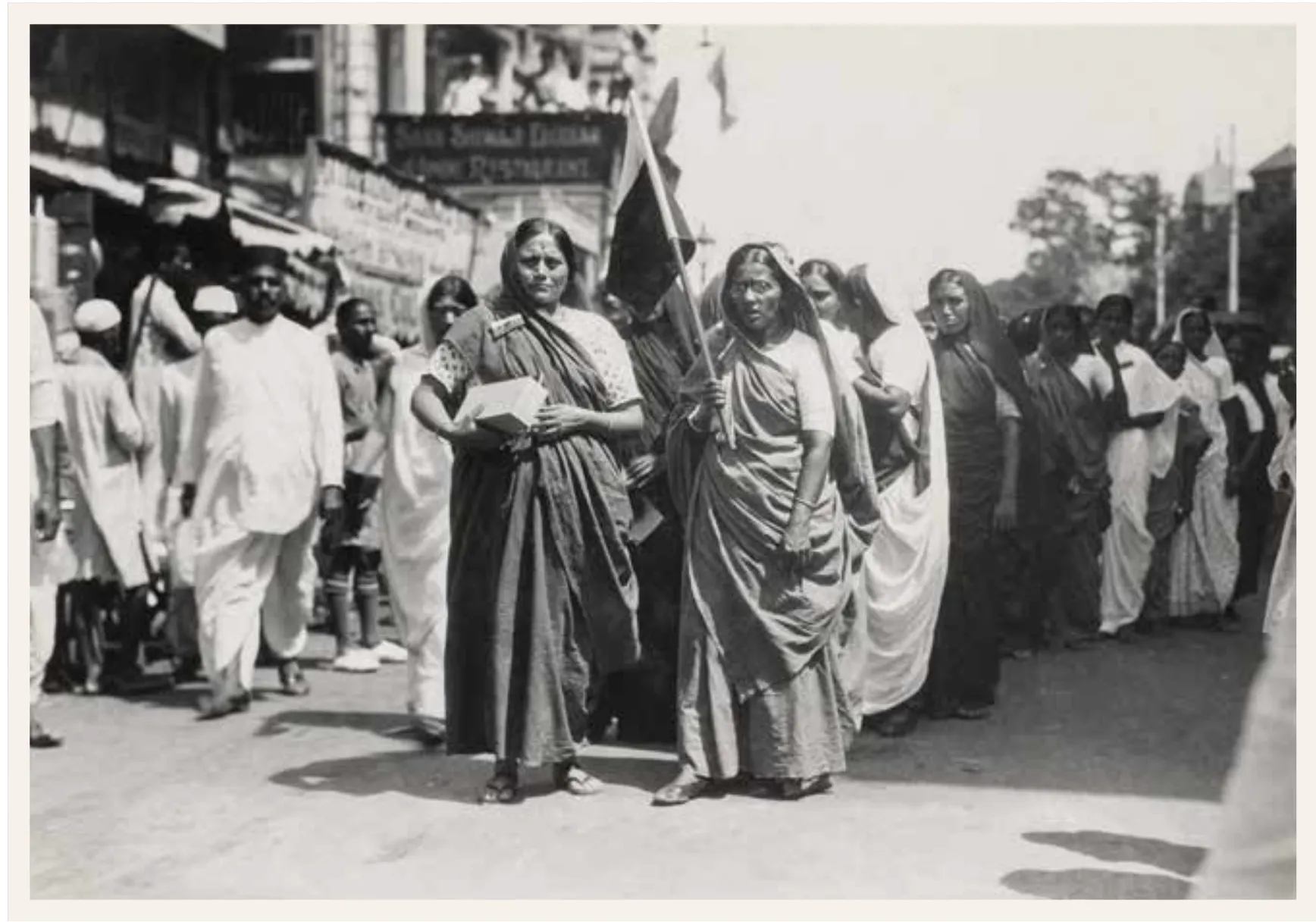 Women leading a boycott procession while holding the provisional national flag