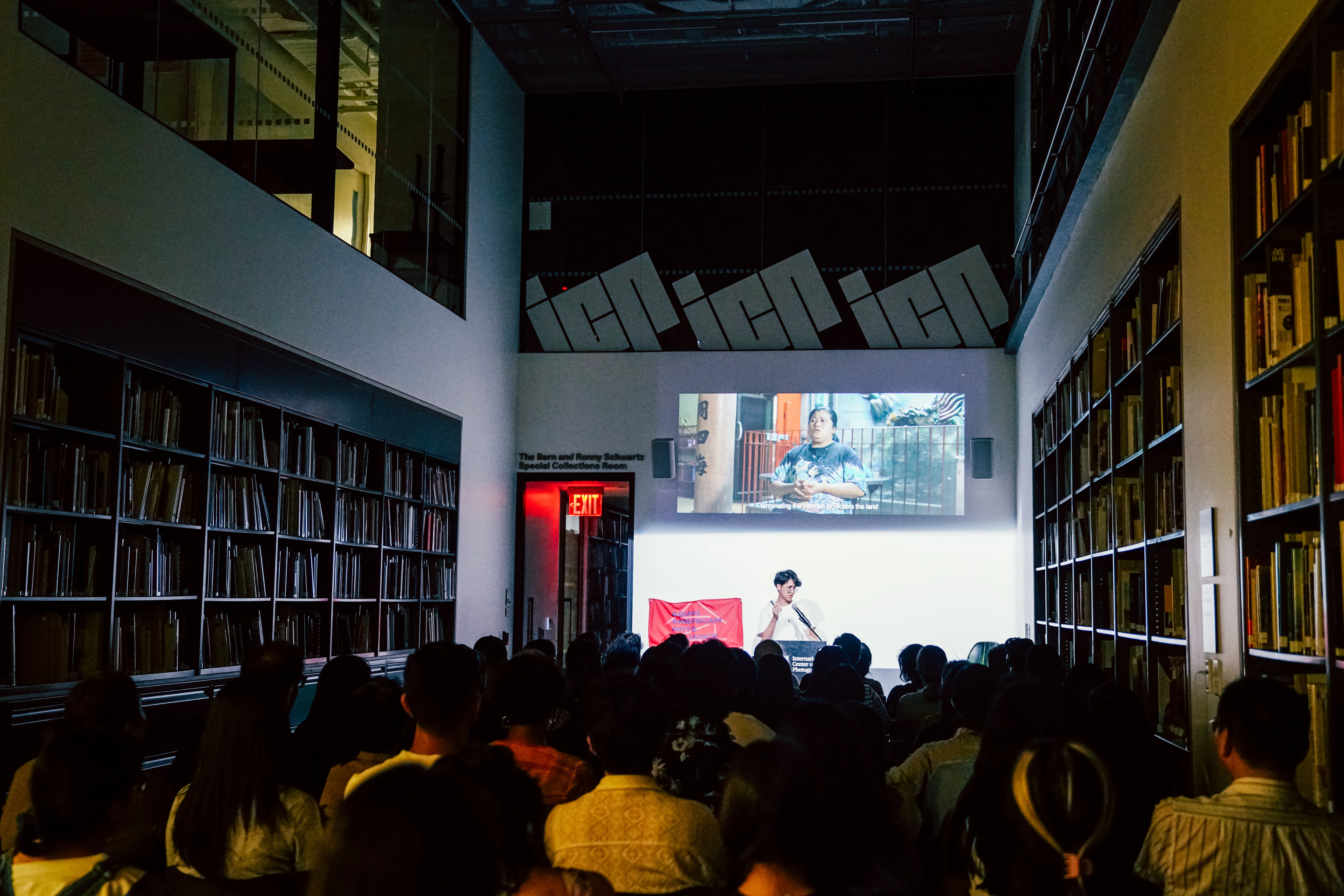 a person talking in front of crowded