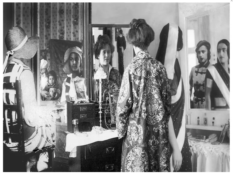 A lady looking into a mirror.