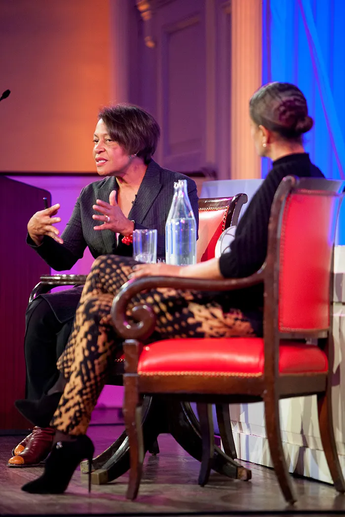 Two woman talking while sitting.