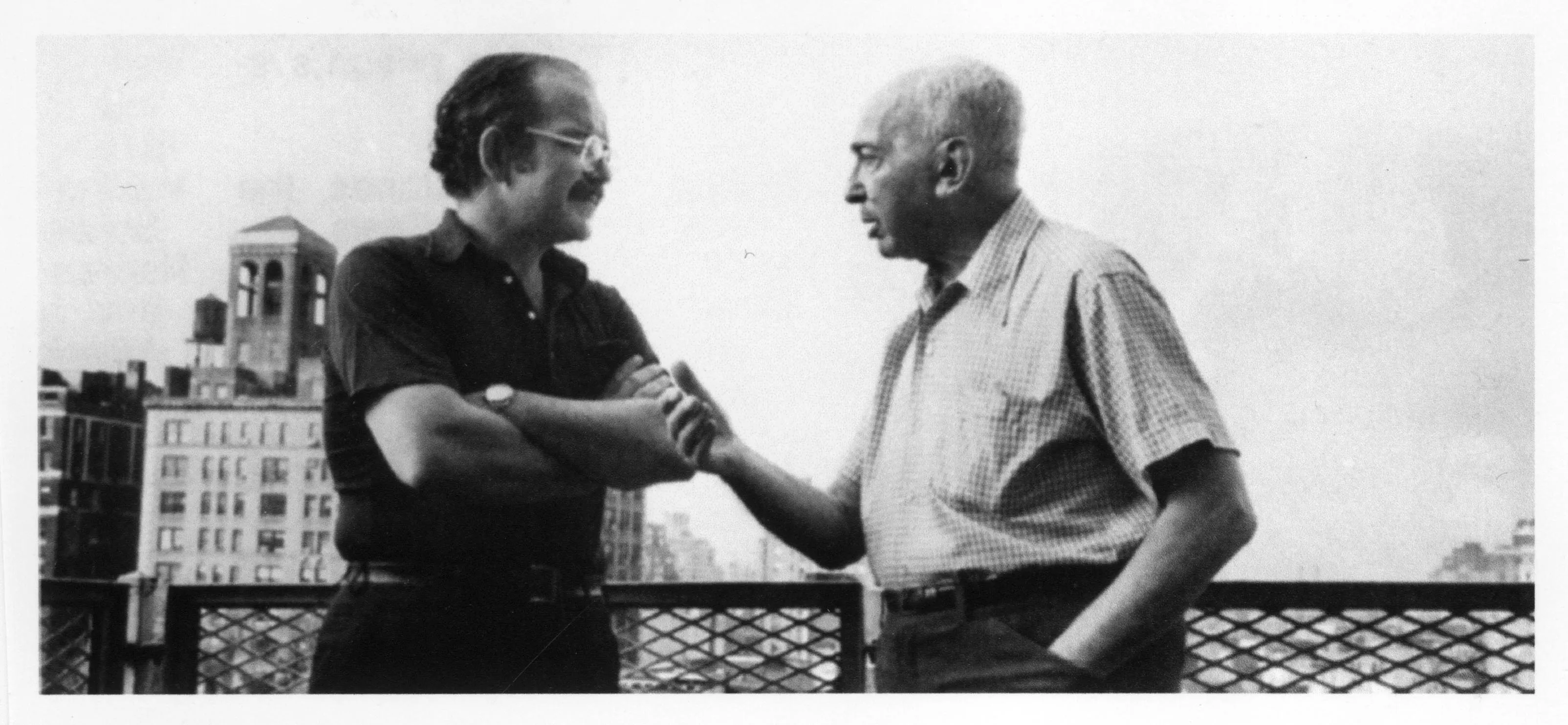 Two elderly man talking outside.