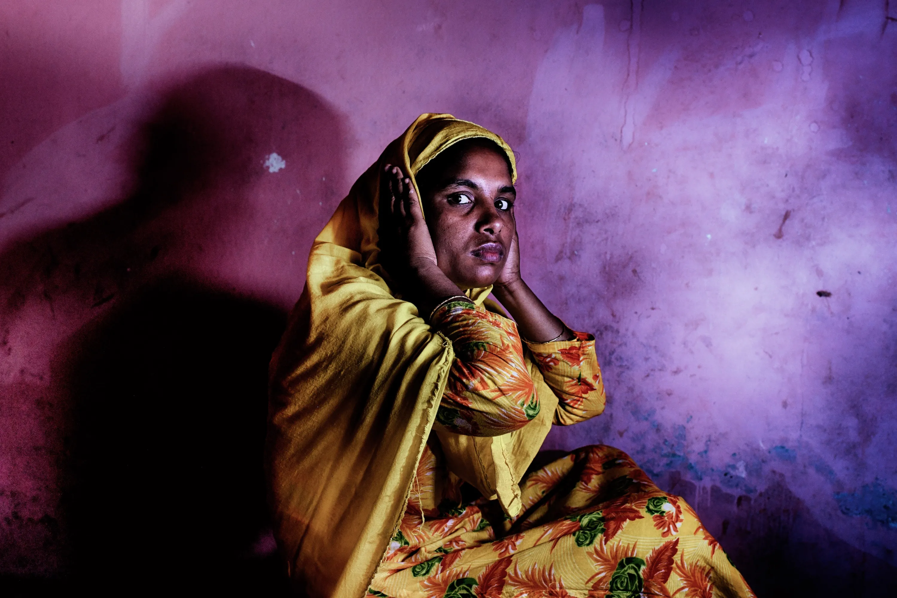 A woman covering her ears.