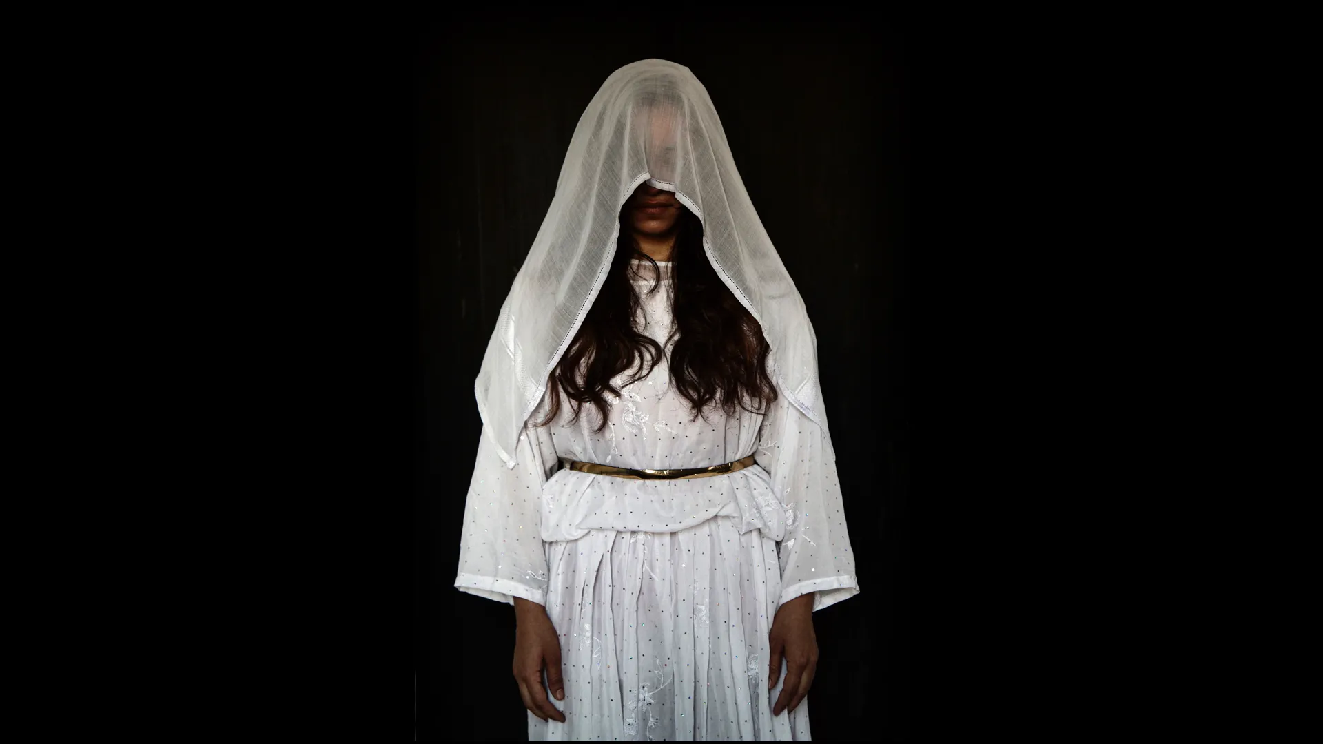 A person wearing a white veil.
