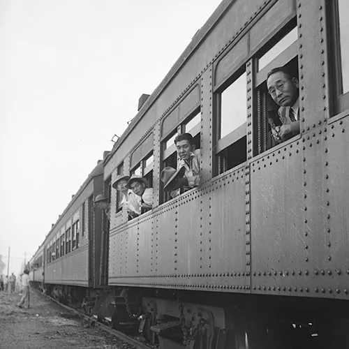 Japanese Americans being taken by train during WWII. 