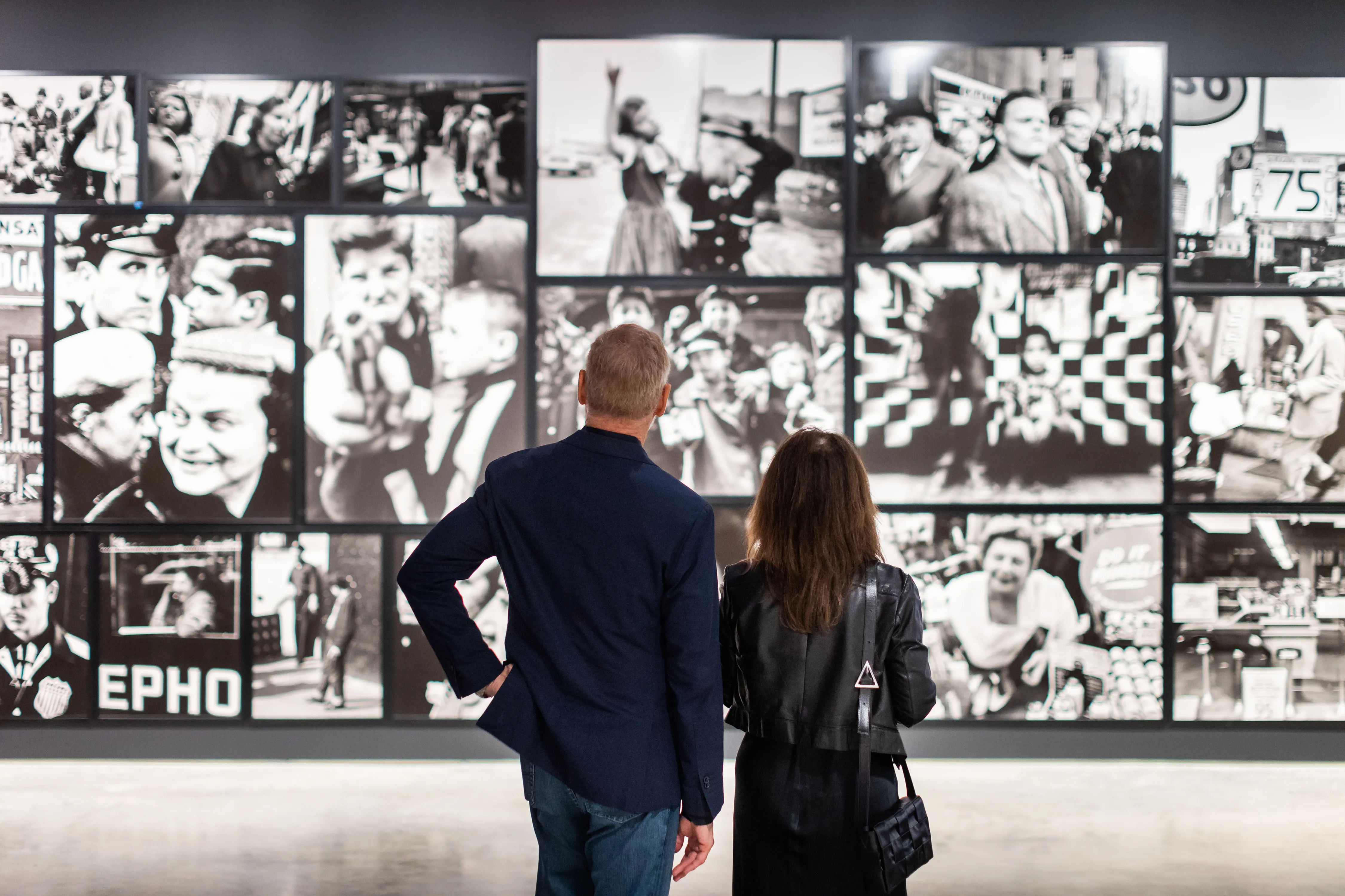 Two people looking at old photos
