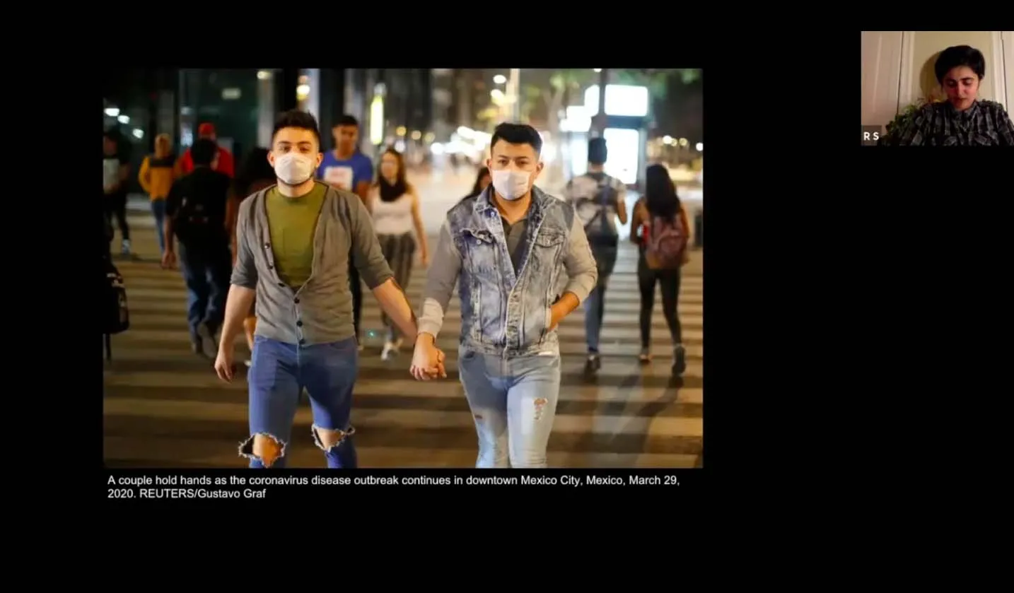 Two men holding hands.