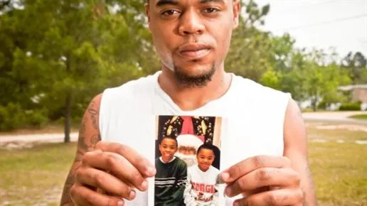 A man holding up a picture.