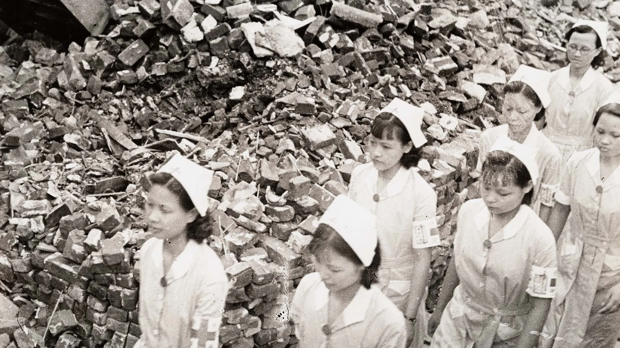 Nurses walking next to debris.