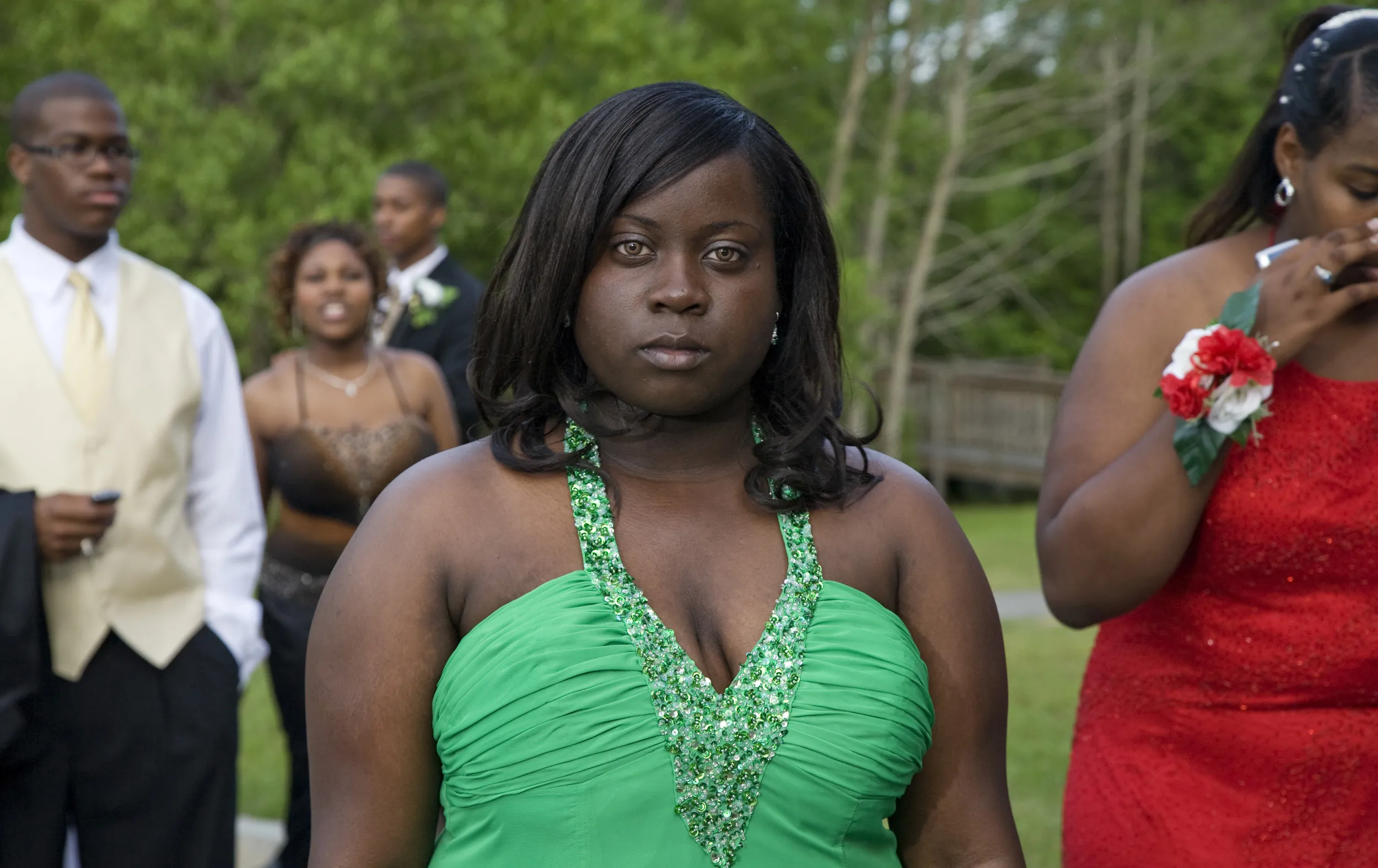 A picture of a woman outside in a green dress.