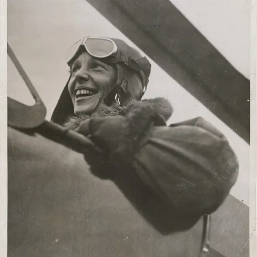 Amelia Earhart in a biplane.
