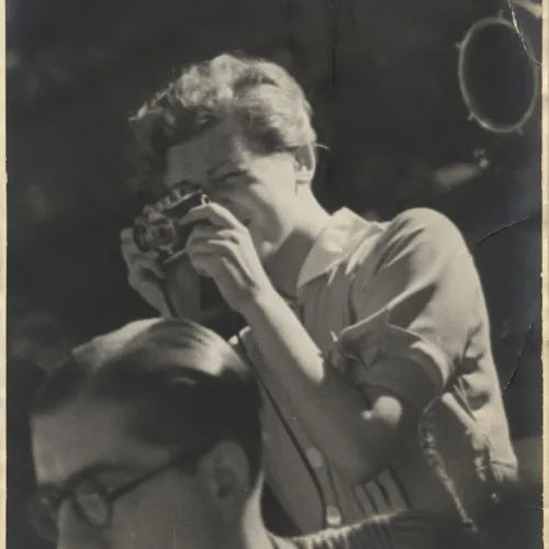 A woman preparing to take a photograph.