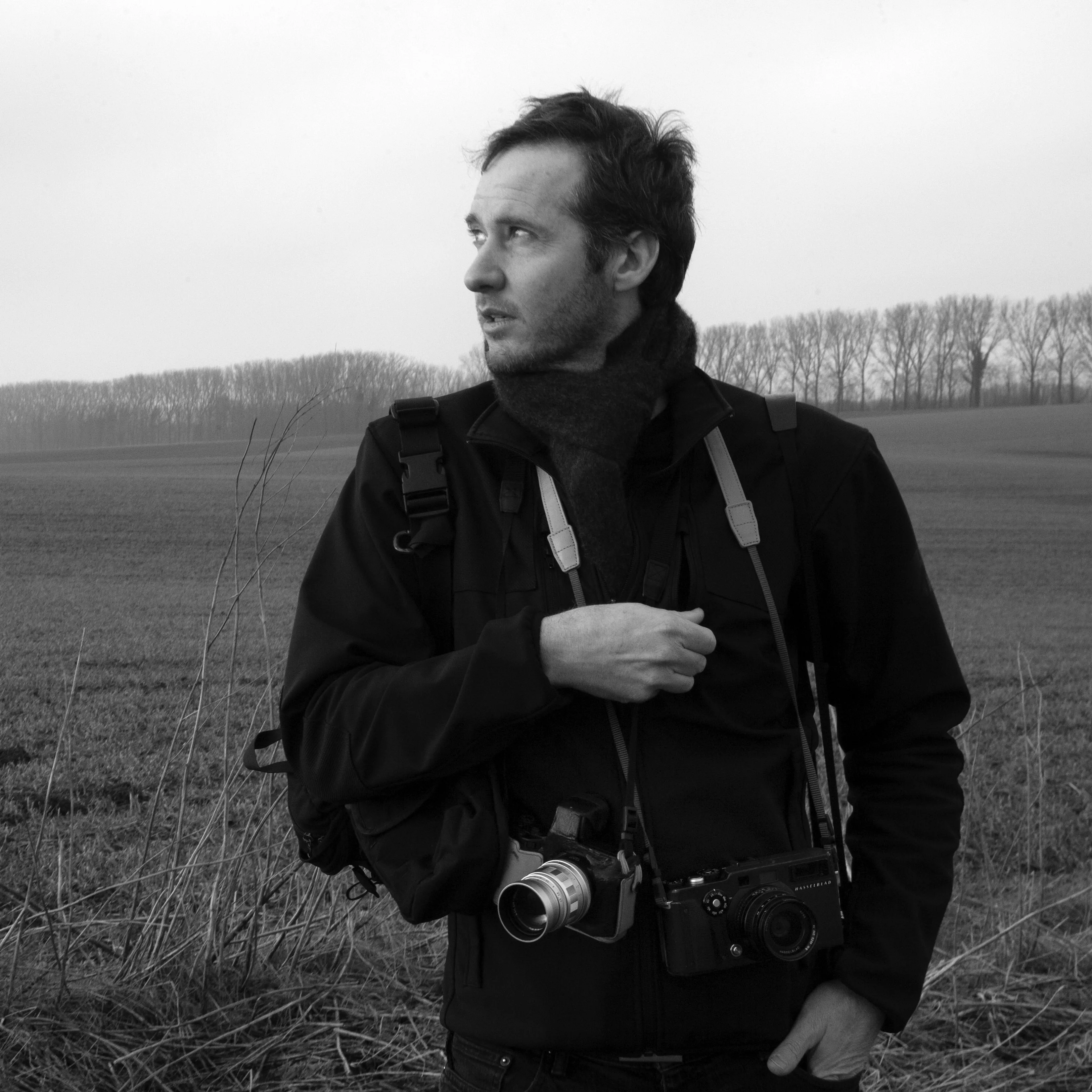 A man outside with two cameras.